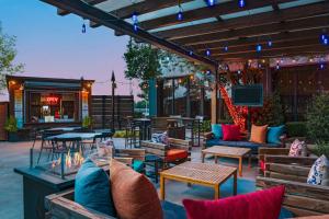 a patio with couches and tables and a tv at Sheraton Oklahoma City Downtown Hotel in Oklahoma City