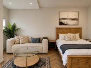a living room with a bed and a couch at 410 On Park in Cape Town
