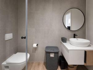 a bathroom with a toilet and a sink and a mirror at 410 On Park in Cape Town