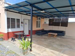 a patio with a couch and a table at Laman D'Manees in Kampung Bukit