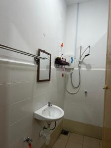 a bathroom with a sink and a shower at Laman D'Manees in Kampung Bukit +4 photos