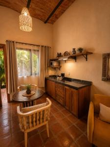 a kitchen with a counter and a table in a room at Hotel Boutique Sol y Luna SPA in Ajijic