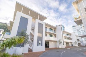 an exterior view of a building with a large doorway at Capri on Pilot Bay in Mount Maunganui