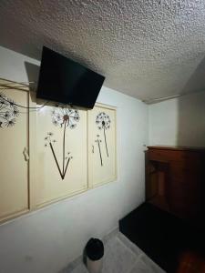 a room with two paintings of flowers on the wall at Nuevo Hotel Transportador in Bogotá