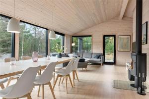 a dining room and living room with a table and chairs at 0410-Romo-Strandskaden-15 in Høm