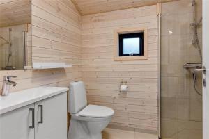 a bathroom with a toilet and a sink and a shower at 0410-Romo-Strandskaden-15 in Høm +20 photos