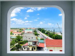 a view of a city from a window at Nhật Lệ River Hotel Quảng Bình in Huân Cát