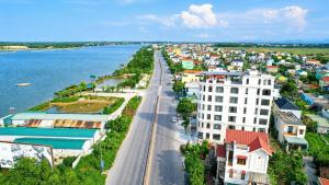 an aerial view of a city next to the water at Nhật Lệ River Hotel Quảng Bình in Huân Cát