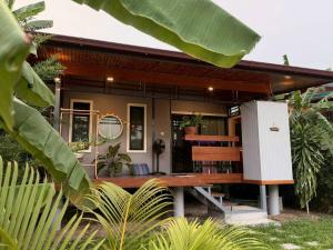 a house with a bench in front of it at C S phangan Villa in Ban Madua Wan