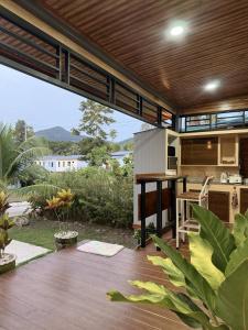 an outdoor kitchen with a large patio with a table at C S phangan Villa in Ban Madua Wan