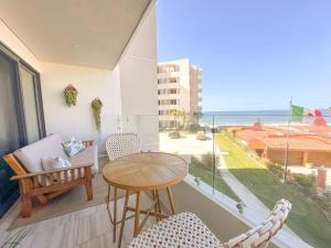 a room with a table and chairs and a view of the ocean at Wabi Sabi in Rosarito