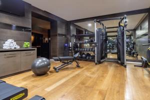 a gym with exercise equipment in a room at Meliá Genova in Genoa +65 photos