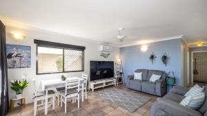 a living room with a couch and a table at Great Views, Ground Floor Unit in Bongaree