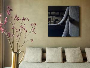 a vase with flowers in it sitting on a couch at ME by Meliá Milan Il Duca in Milan +92 photos