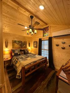 a bedroom with a bed in a log cabin at The Dapper Duck Log Cabin in Cosby