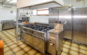 a large kitchen with stainless steel appliances at Oasi Di Cocciola in Badia Tedalda