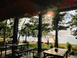 a view of the ocean from a restaurant with benches at Villa Allure Koh Mak in Ko Mak