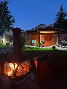 a vase sitting on a table in front of a house at Ramonda Serbica - Gorge View & Peacful Nature Retreat in Niš