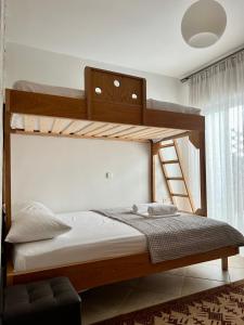a bedroom with two bunk beds and a ladder at THREE GRACES filikon in Zakynthos