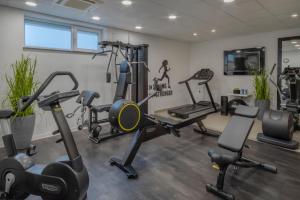 a gym with several treadmills and exercise bikes at INNSiDE by Meliá Aachen in Aachen