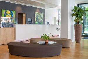 a living room with a couch and a table at INNSiDE by Meliá Aachen in Aachen