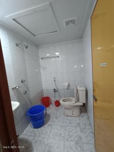 a bathroom with a toilet and a sink and a tub at Hotel Green Land in Bāndarban
