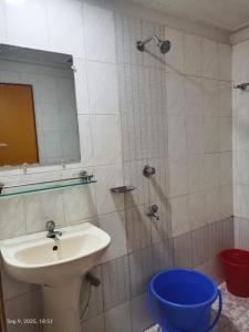 a bathroom with a sink and a shower with a mirror at Hotel Green Land in Bāndarban