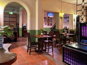 a restaurant with tables and chairs in a room at Inthira Thakhek in Thakhek