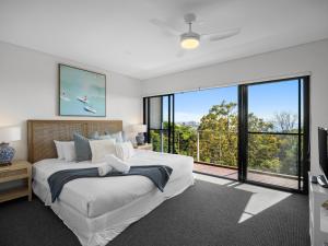 a bedroom with a large bed and a large window at The Point Coolum in Coolum Beach +165 photos