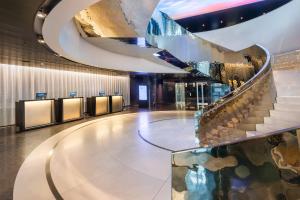 a lobby with a spiral staircase in a building at Meliá Vienna in Vienna