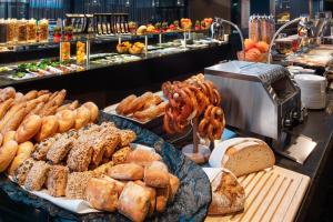 a buffet of bread and pastries in a bakery at Meliá Vienna in Vienna