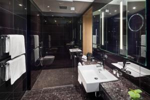 a bathroom with a sink and a shower at Meliá Vienna in Vienna