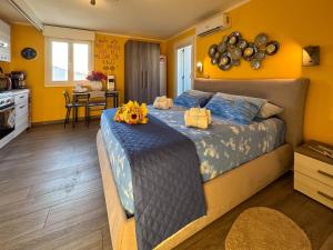 a bedroom with a bed with two pumpkins on it at Il Panoramico - Terrazza e Jacuzzi in Neviano