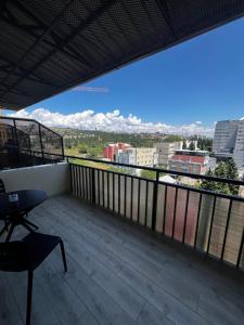 a balcony with a view of a city at Seven Rooms Hotel in Tbilisi City