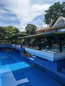 a resort with a swimming pool and a building at Chevilly Resort & Camp in Bogor