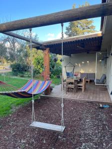 a porch with a hammock and a patio at חלום ליד הנחל in ‘Amir