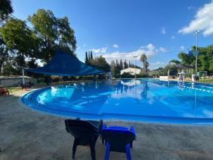 a large swimming pool with two chairs in front of it at חלום ליד הנחל in ‘Amir