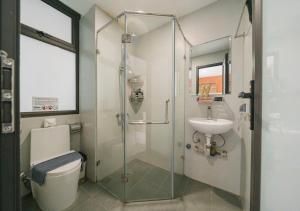 a bathroom with a shower and a toilet and a sink at BOHO Homestay Hanoi - No81 Alley 8 Ton That Thiep in Hanoi +32 photos