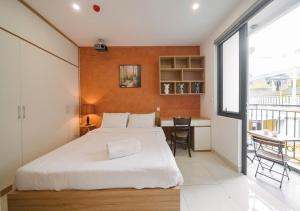 a bedroom with a large bed and a table with chairs at BOHO Homestay Hanoi - No81 Alley 8 Ton That Thiep in Hanoi