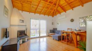 a living room with a table and a couch and a dining room at Coollyhouse Keklik tepe Urla in Urla