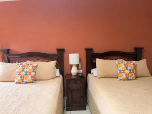 two beds sitting next to each other in a bedroom at Inari Guatemala in Guatemala