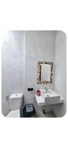 a bathroom with a sink and a toilet and a mirror at Join Homestay in Kuta Lombok +56 photos