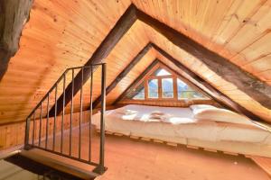 a bed in a room in a wooden house at Rustico Caterina - Corippo- Happy Rentals in Corippo