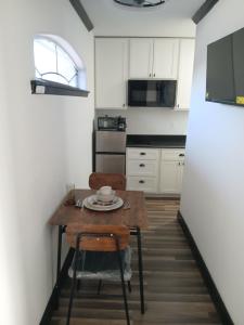 a small kitchen with a wooden table and a chair at Cozy Retreat 1 Bed and Bath in San Antonio +7 photos