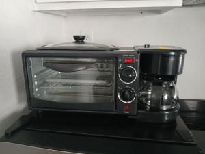 a toaster oven sitting on top of a counter at Cozy Retreat 1 Bed and Bath in San Antonio