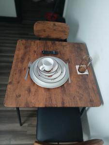 a table with a plate and a cup on it at Cozy Retreat 1 Bed and Bath in San Antonio