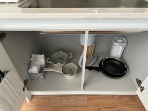a kitchen under a counter with pots and pans at Seoungho Kim in Ch'ŏngsap'o