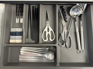 a drawer filled with utensils and other kitchen items at Seoungho Kim in Ch'ŏngsap'o