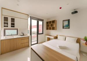 a bedroom with a large bed and a sink at BOHO Homestay Hanoi - No81 Alley 8 Ton That Thiep in Hanoi