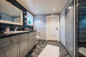 a bathroom with a sink and a toilet at Gamatun cabin in Heimdal +58 photos